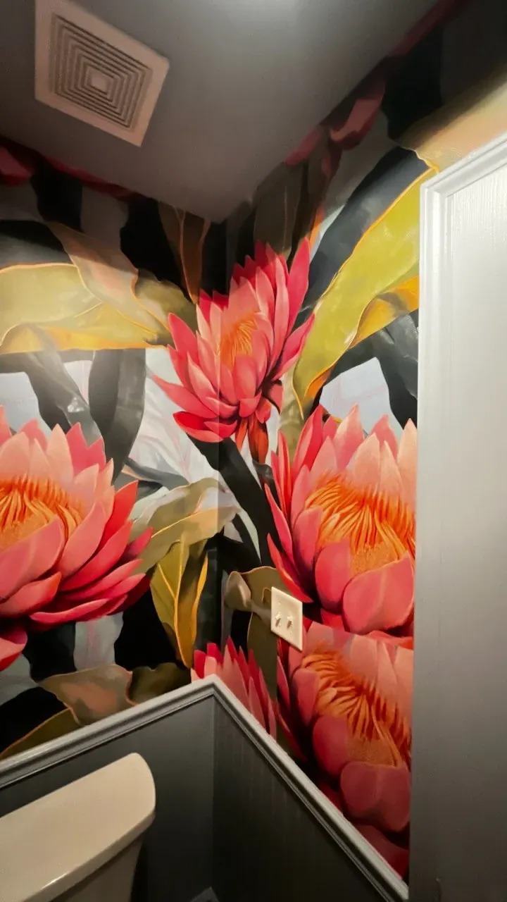 Large pink protea wallpaper above grey beadboard